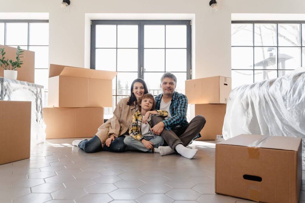 Parents with a child surrounded by boxes