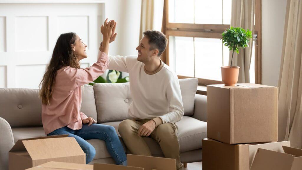 A happy couple preparing for long-distance movers 