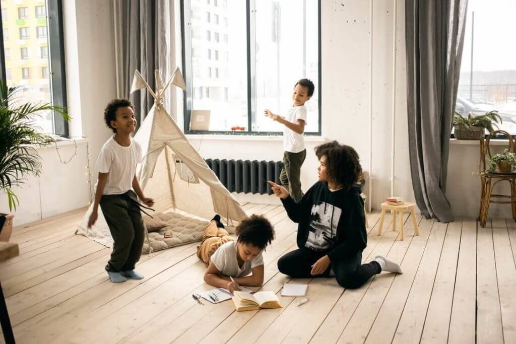 Children with a mother playing in the room