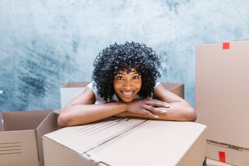 a-girl-leaning-on-the-box-and-smiling