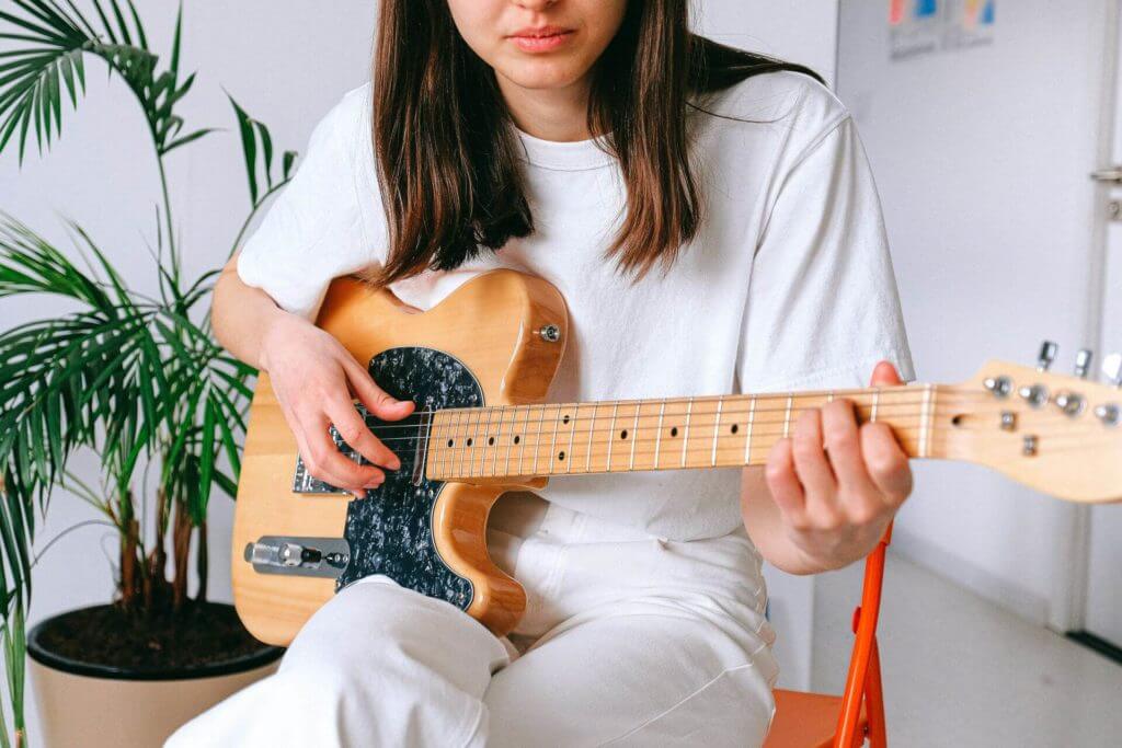 girl playing a guitar