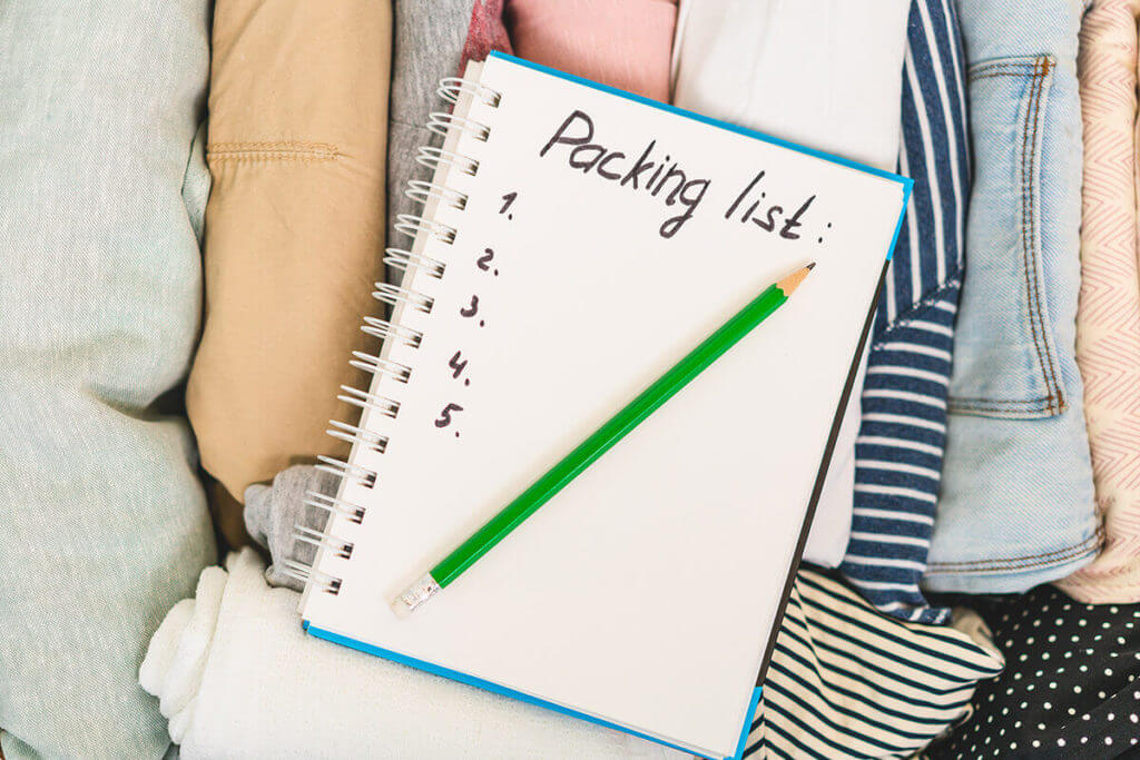 A packing list lying on folded clothes