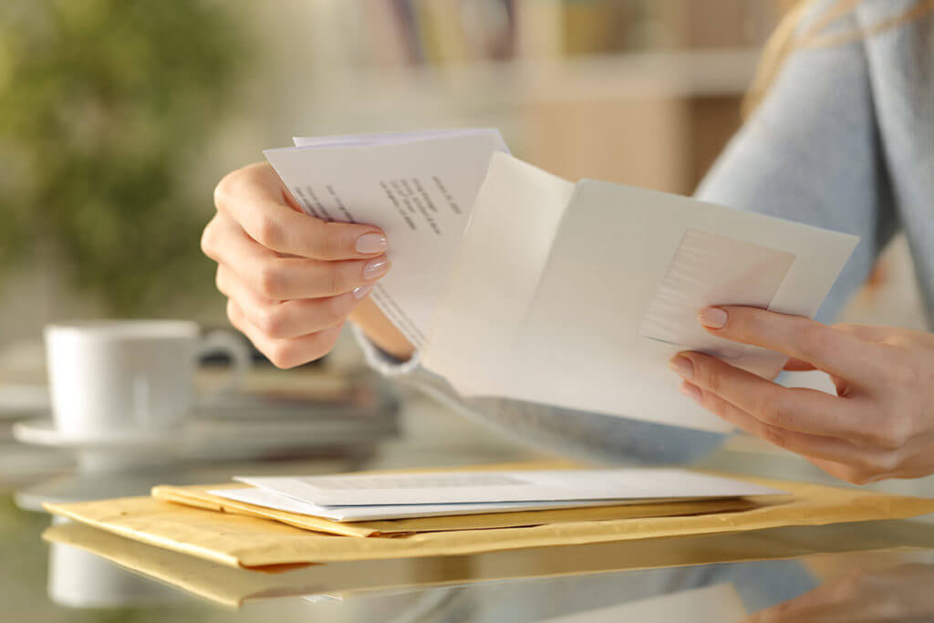 A woman packing boxes and preparing her belongings for a move.