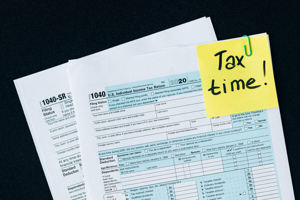 Tax return form and a yellow sticky note