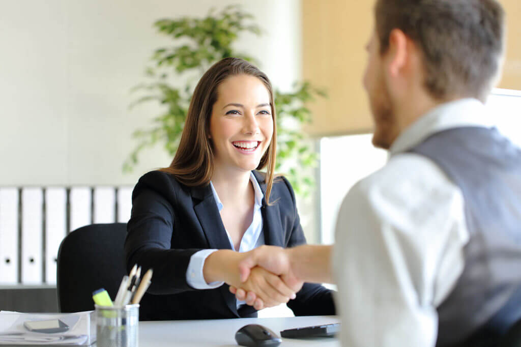 a career adviser shaking hands with a client