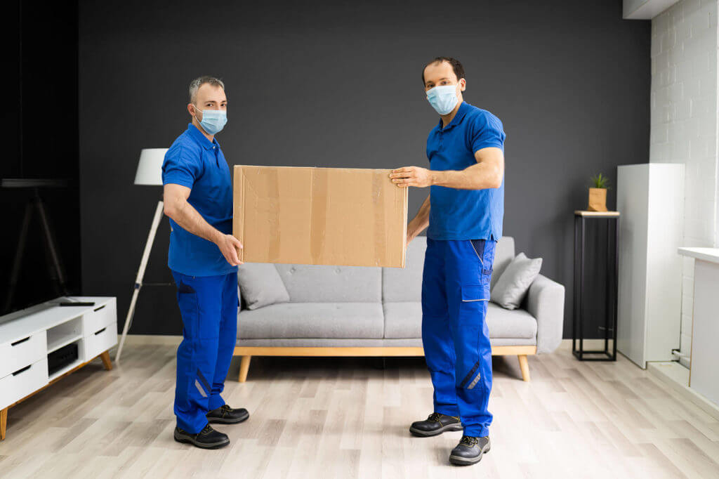 Long-distance movers carrying masks and boxes 