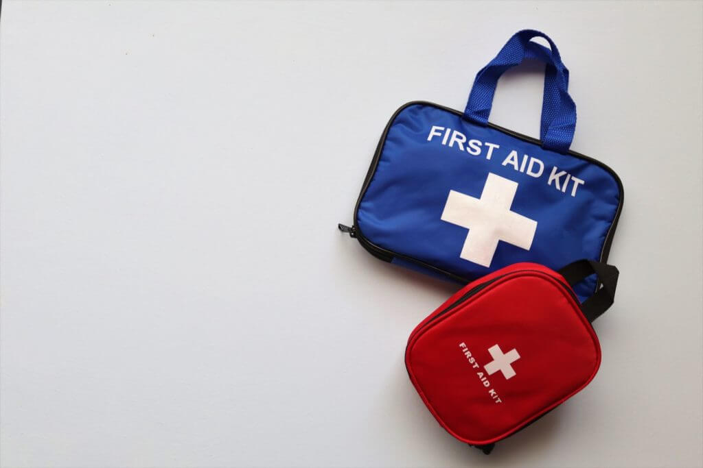 Two first-aid kits on a white surface