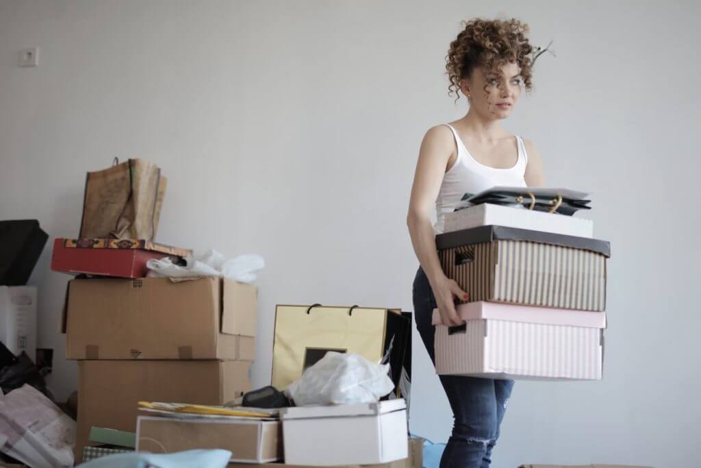 A woman carrying boxes before long-distance moving services