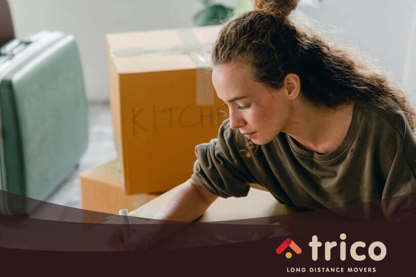 A girl writing on a box
