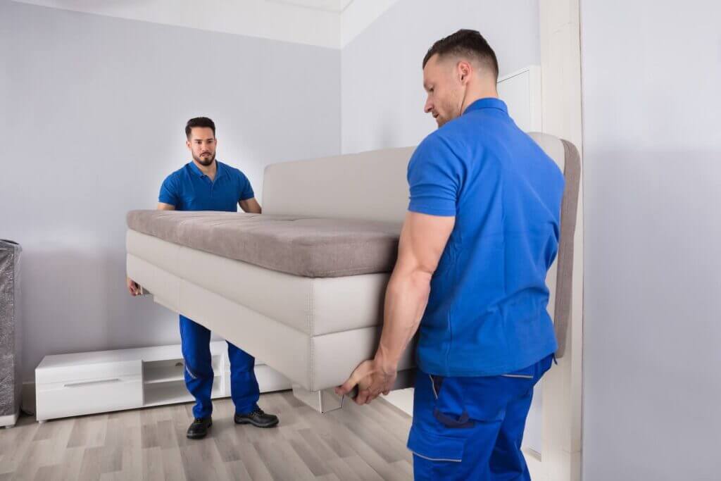 Two movers carrying couch