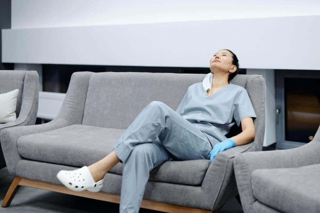 A nurse resting on a couch