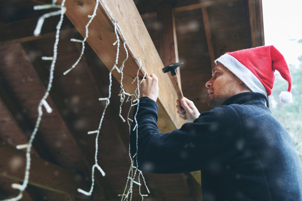 A man setting up Christmas decorations