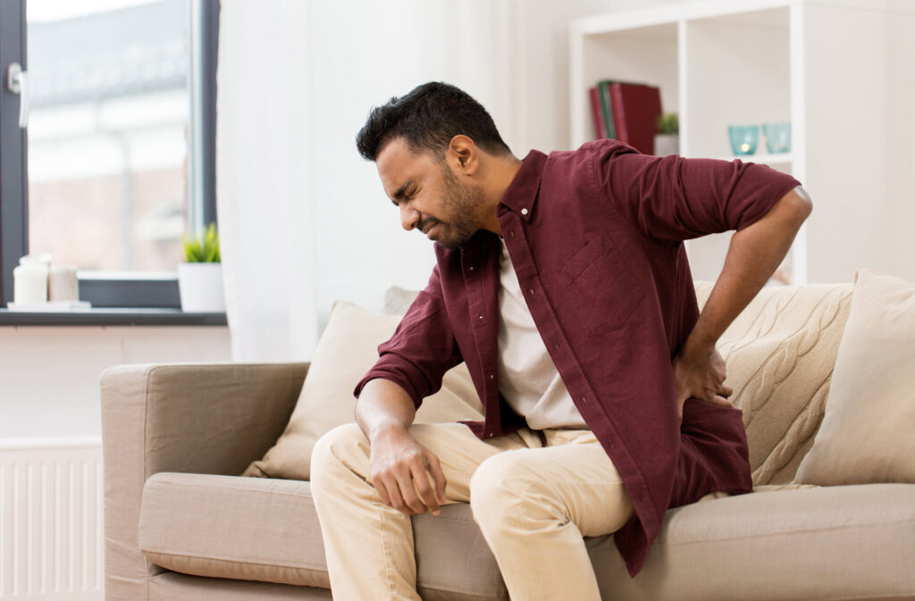 A man feeling pain in his lower back