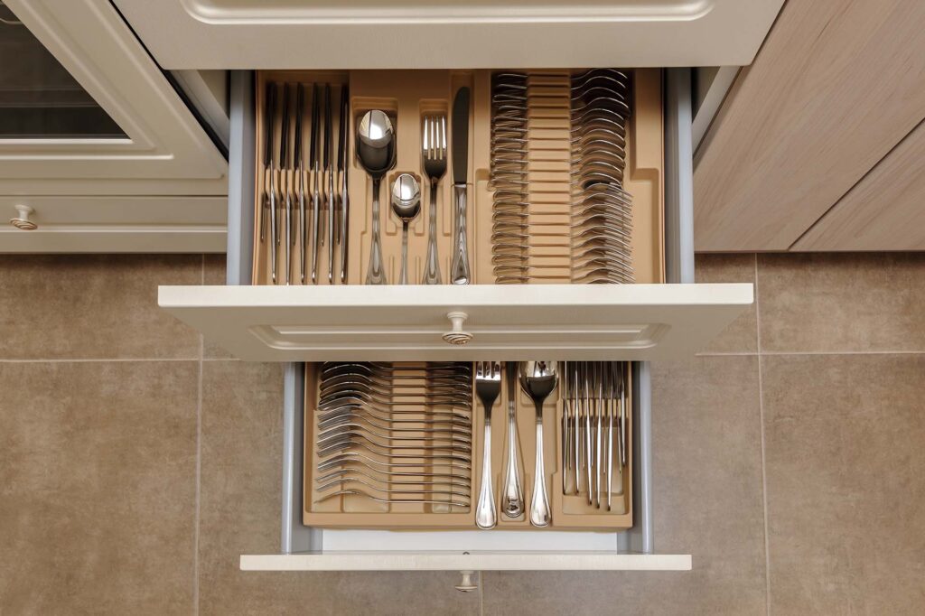 Open drawers with kitchen utensils