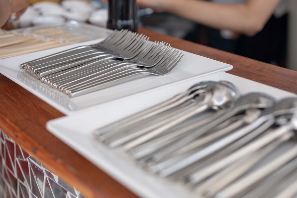  Separate piles of forks and spoons