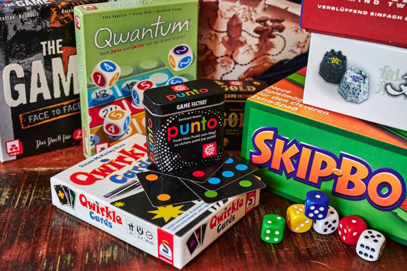 Many different packs of board games and dices as activity against boredom.